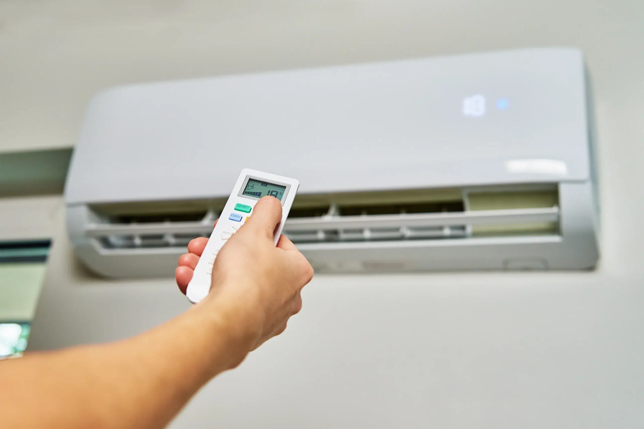 hand adjusting temperature air conditioner scaled