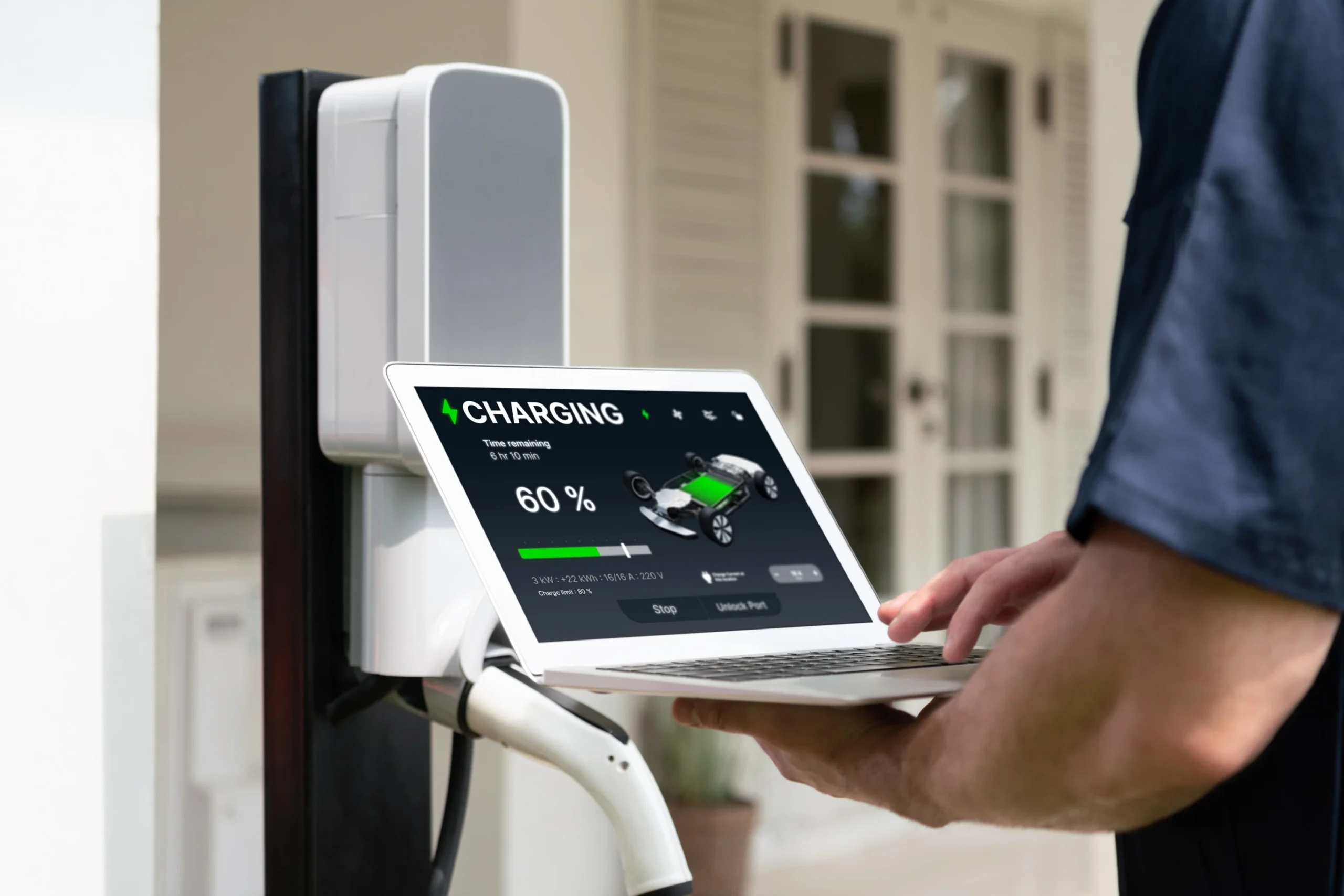 qualified technician working home ev charging station installation making troubleshooting configuration setup charging system with laptop ev home synchronos scaled